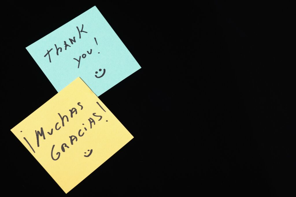 Colorful sticky notes expressing gratitude in English and Spanish